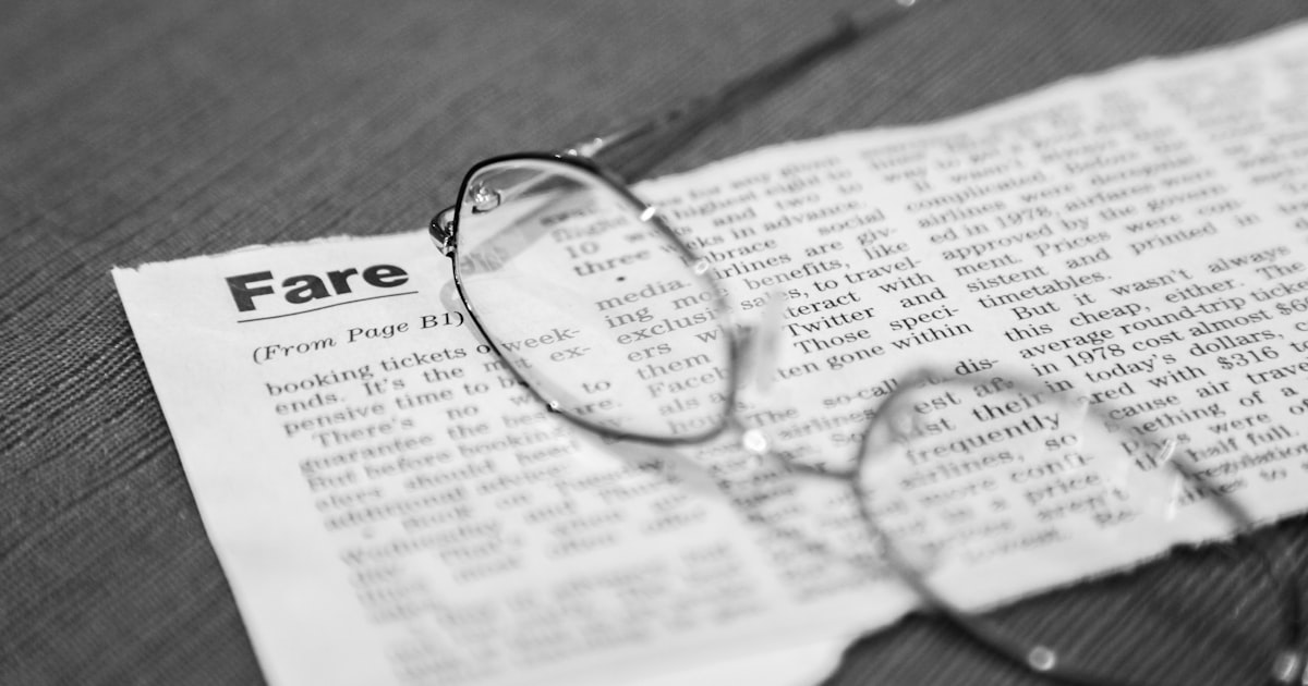 black framed eyeglasses on newspaper