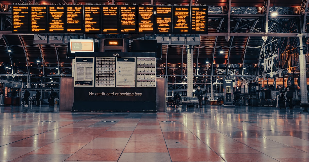 a large airport terminal with a large electronic sign above it
