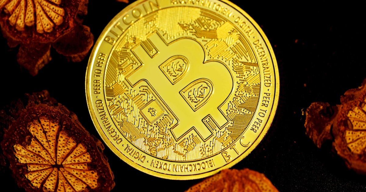 gold round coin on black surface