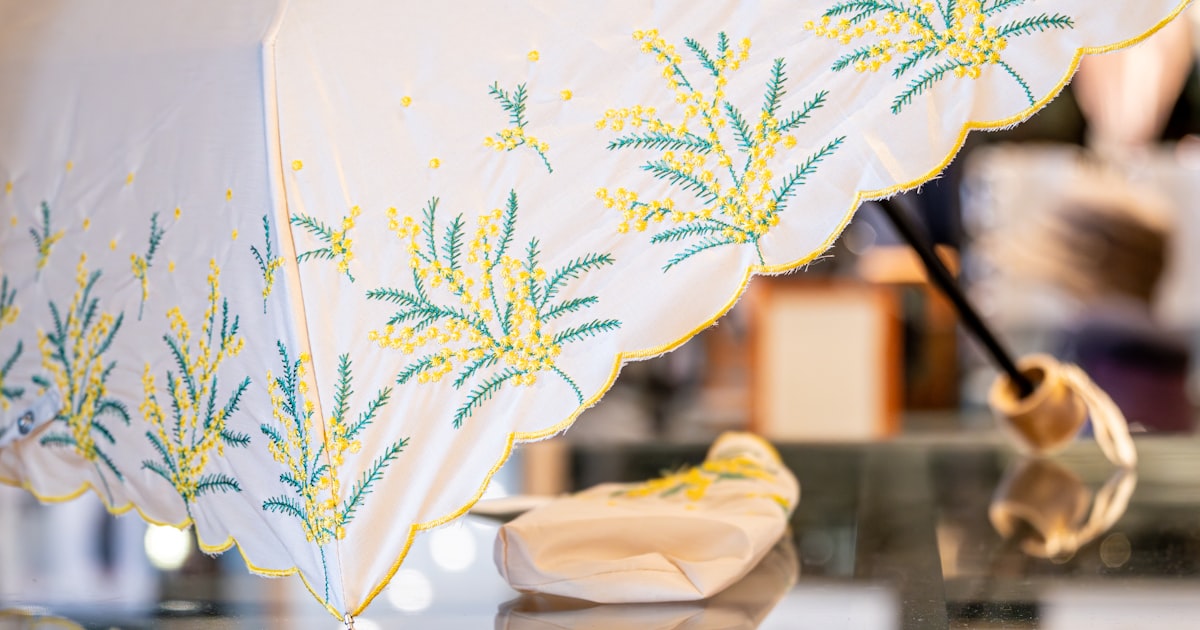 White umbrella with yellow and green floral embroidery