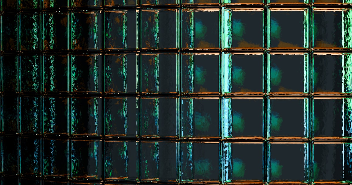 A close up of a metal grate with green paint