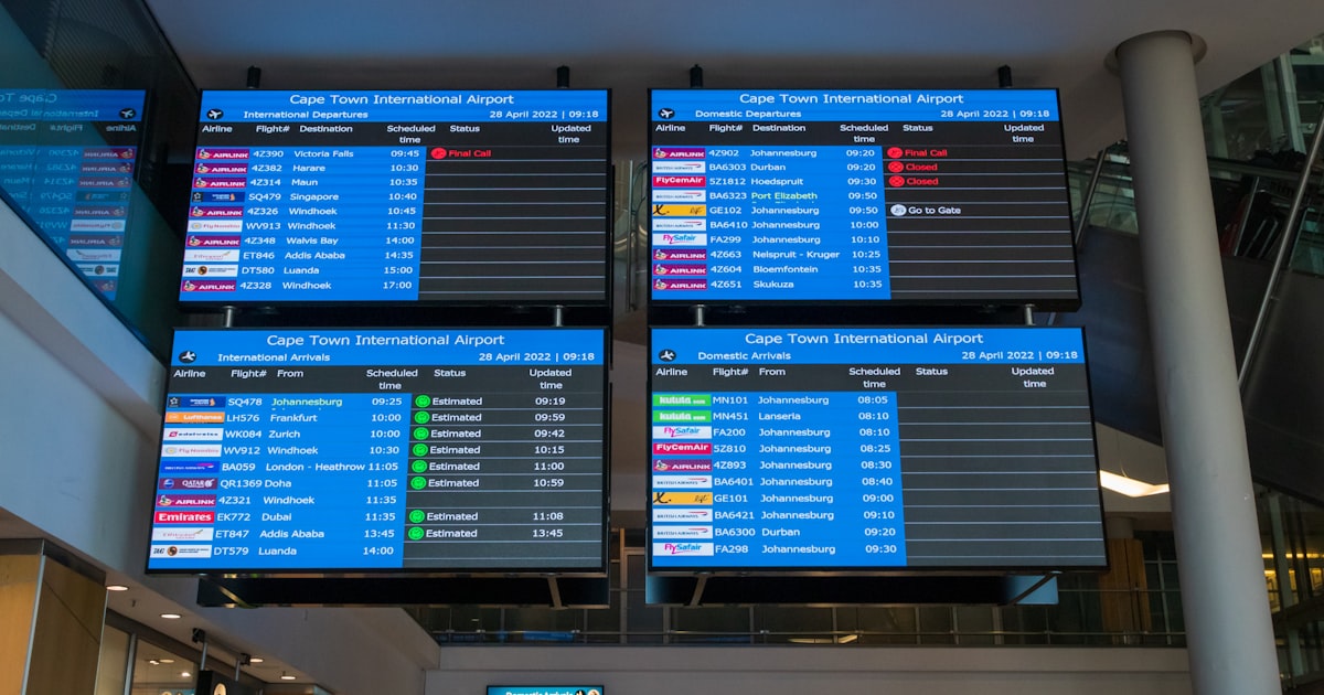 A couple of people walking through an airport