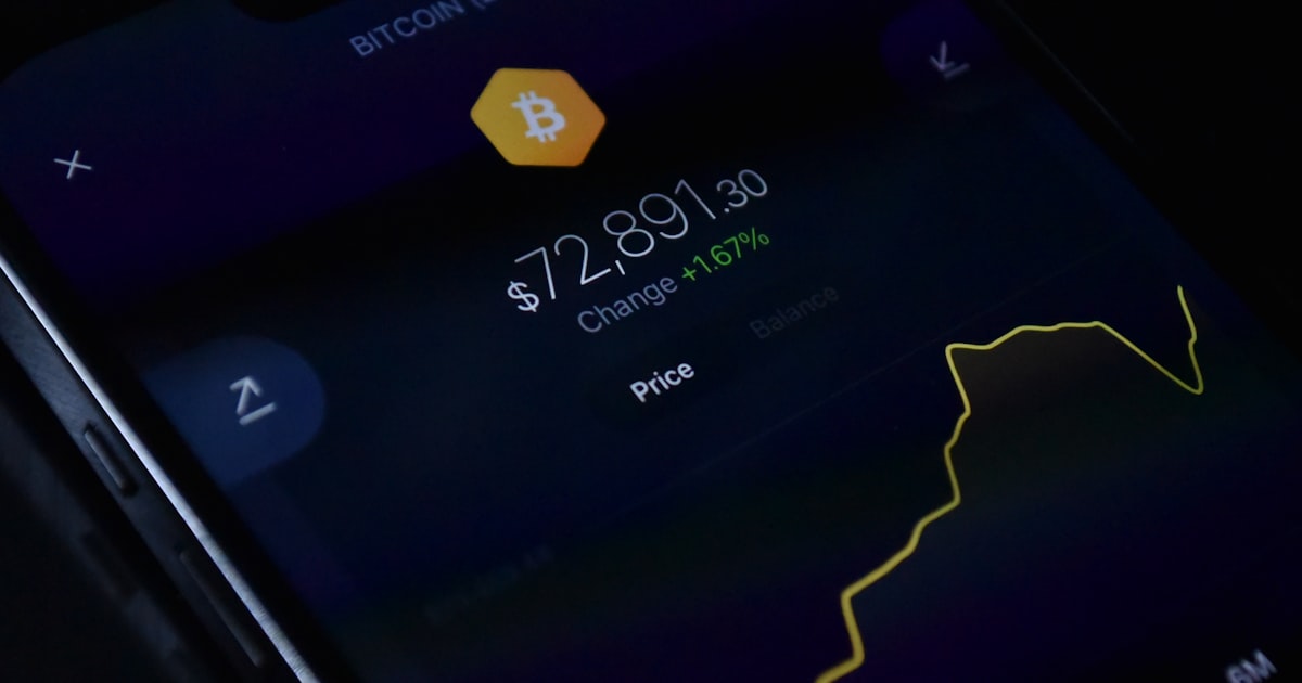 a close up of a cell phone with a bitcoin on it