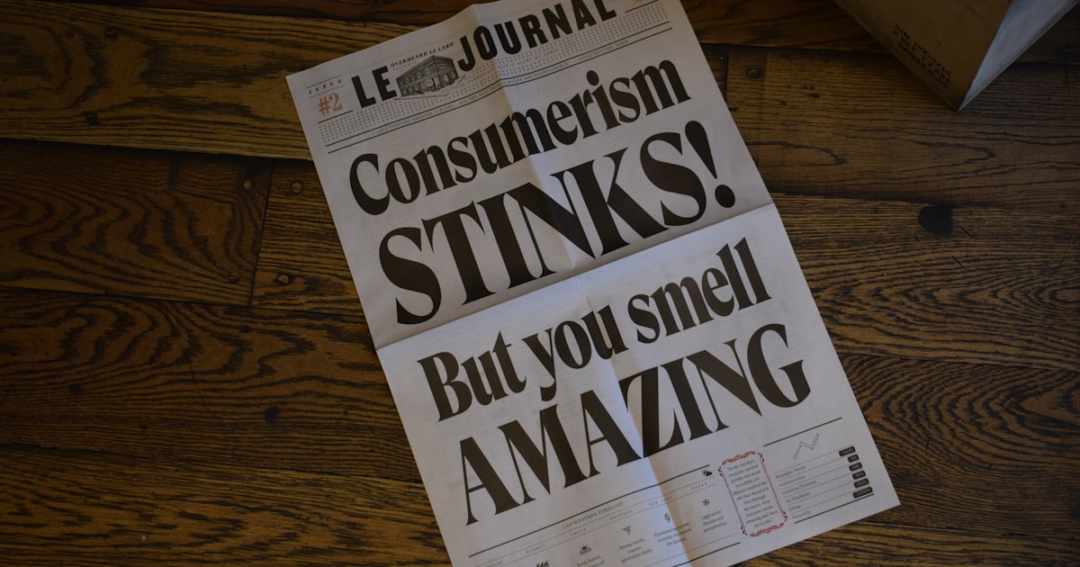 Le Journal newspaper page on wooden surface