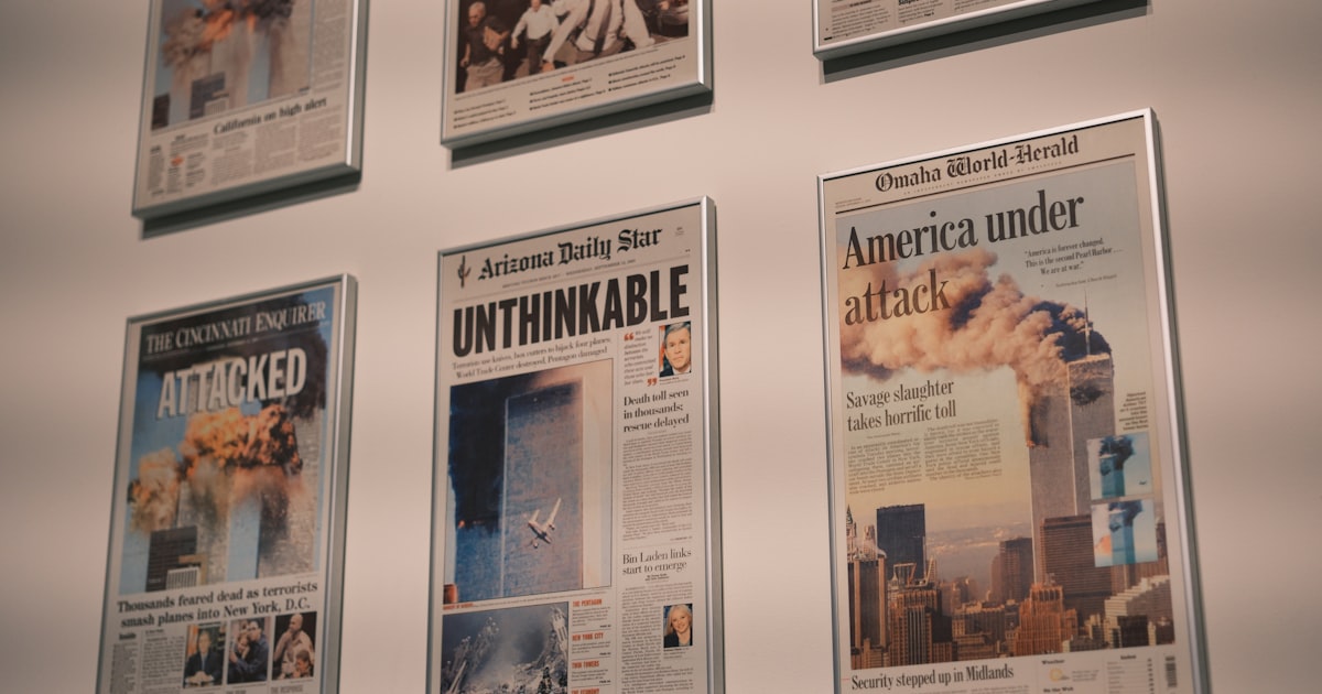 Newspaper headlines depict the 9/11 terrorist attacks.