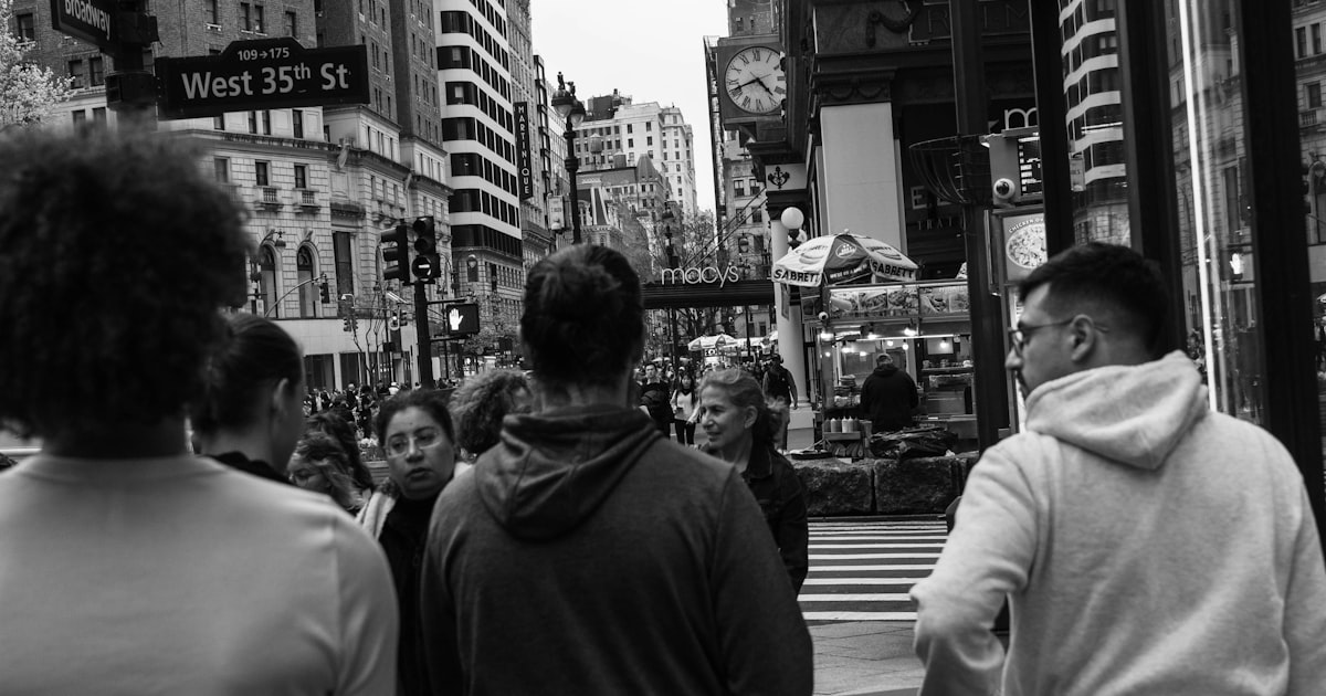 People walk down a busy street in new york city.