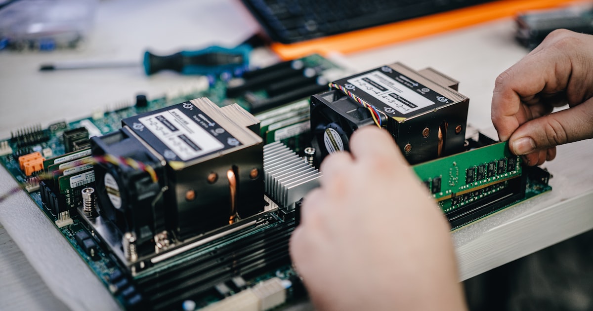 A person working on a computer motherboard