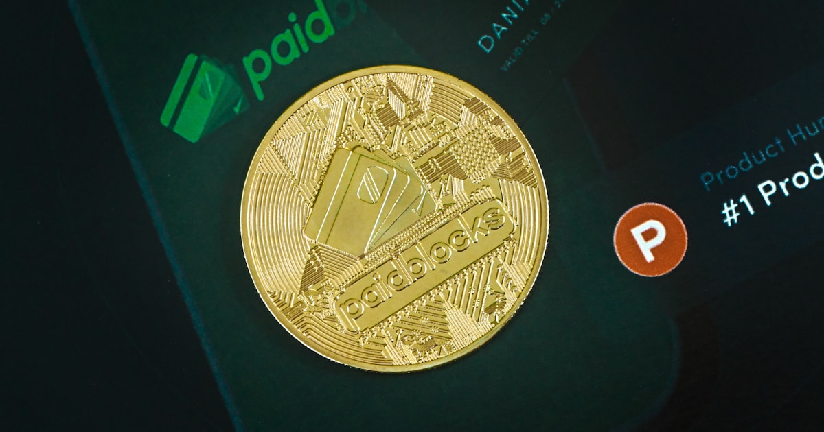 a close up of a gold coin on a cell phone