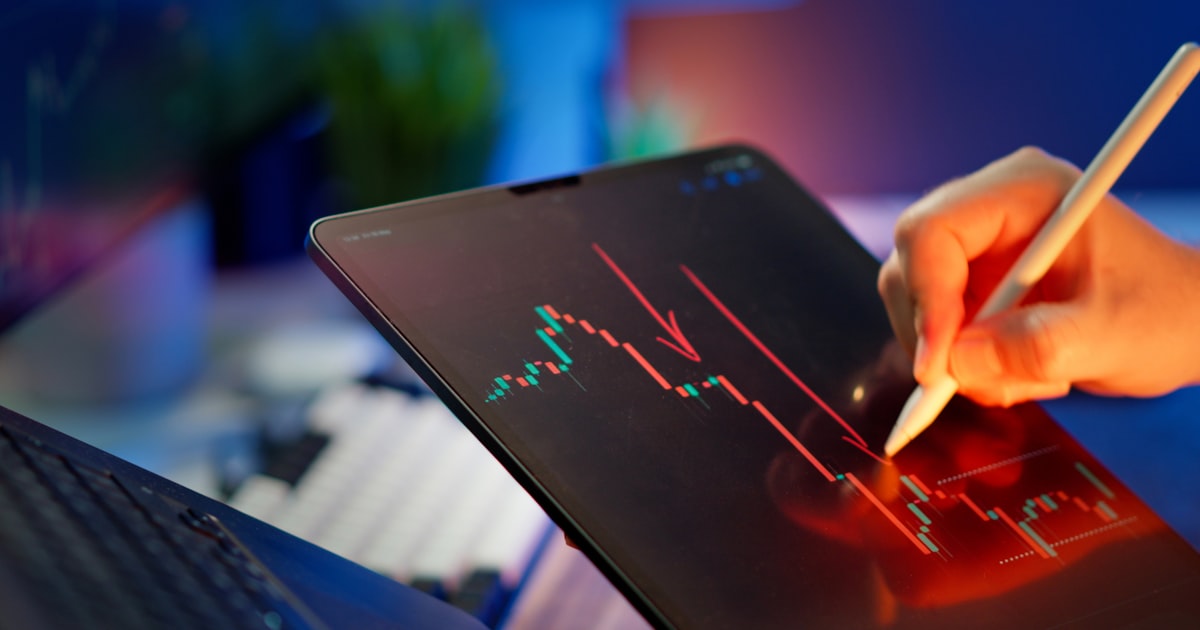 Someone is analyzing a stock market graph.