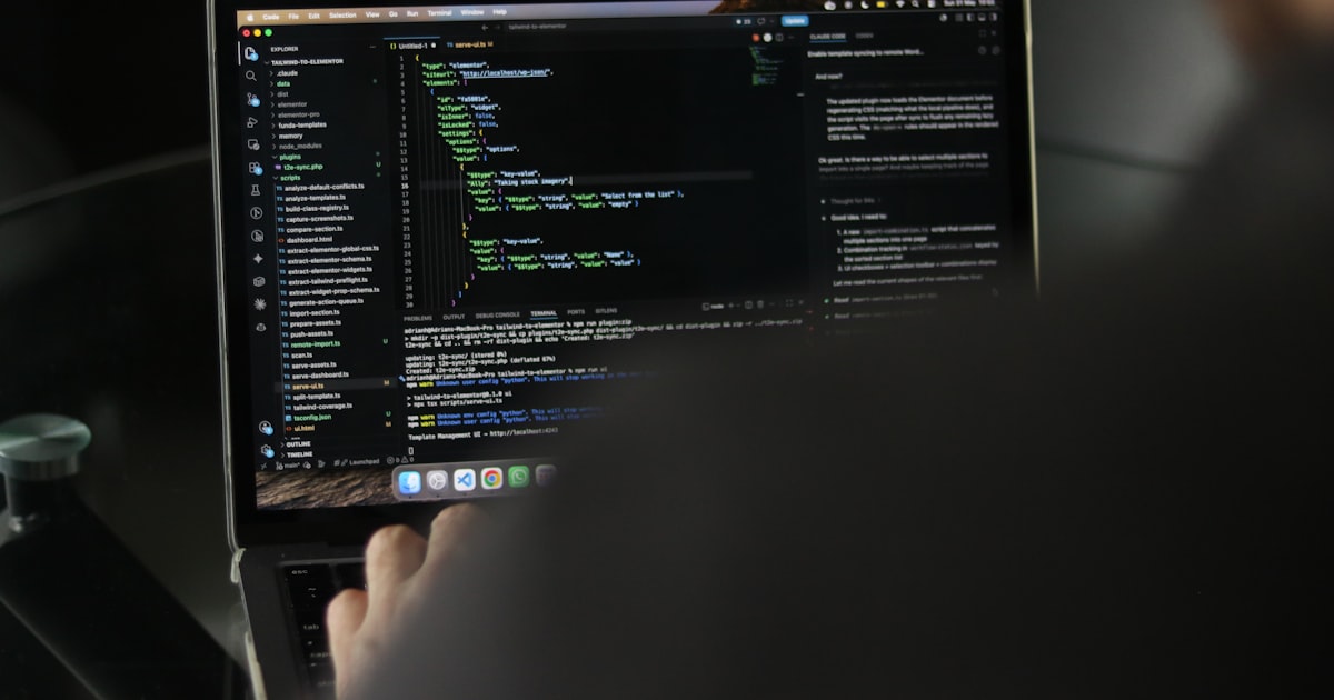 Person typing code on a laptop screen.
