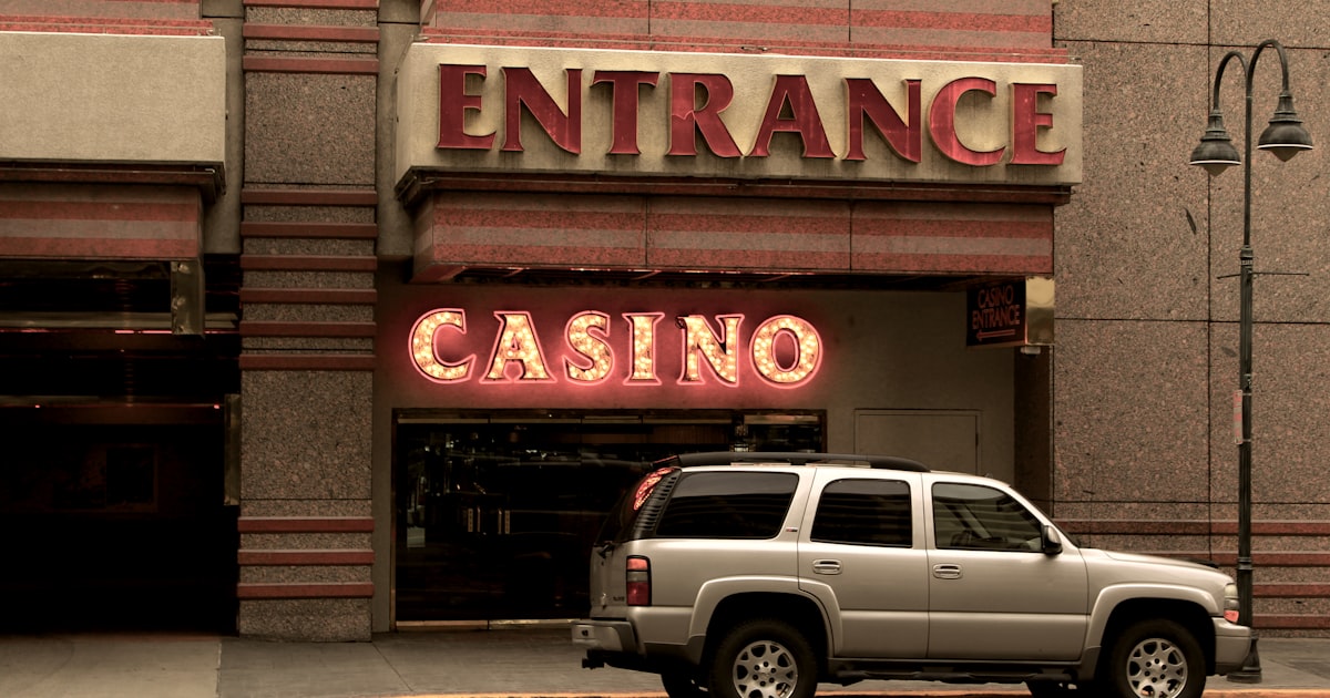 silver SUV parking beside Casino building