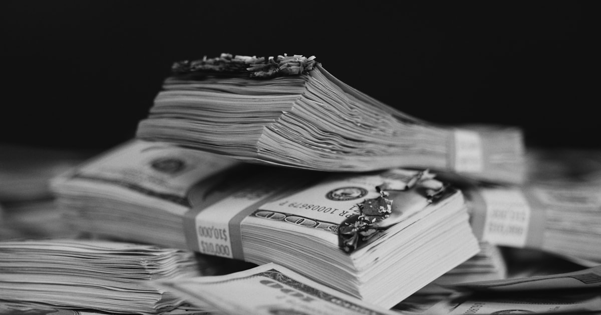 a pile of money sitting on top of a table