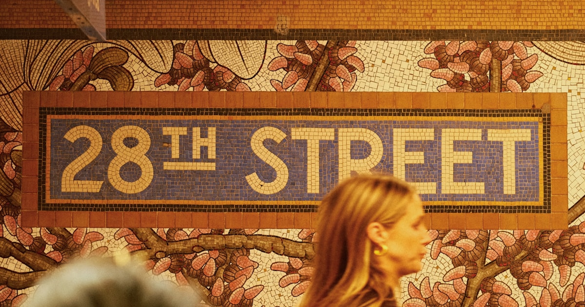 28th street subway station sign with floral wallpaper