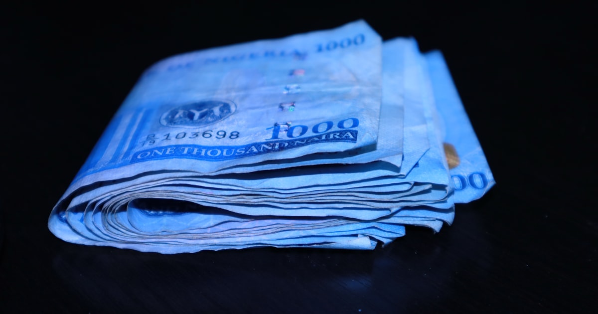 a stack of folded bills sitting on top of a table