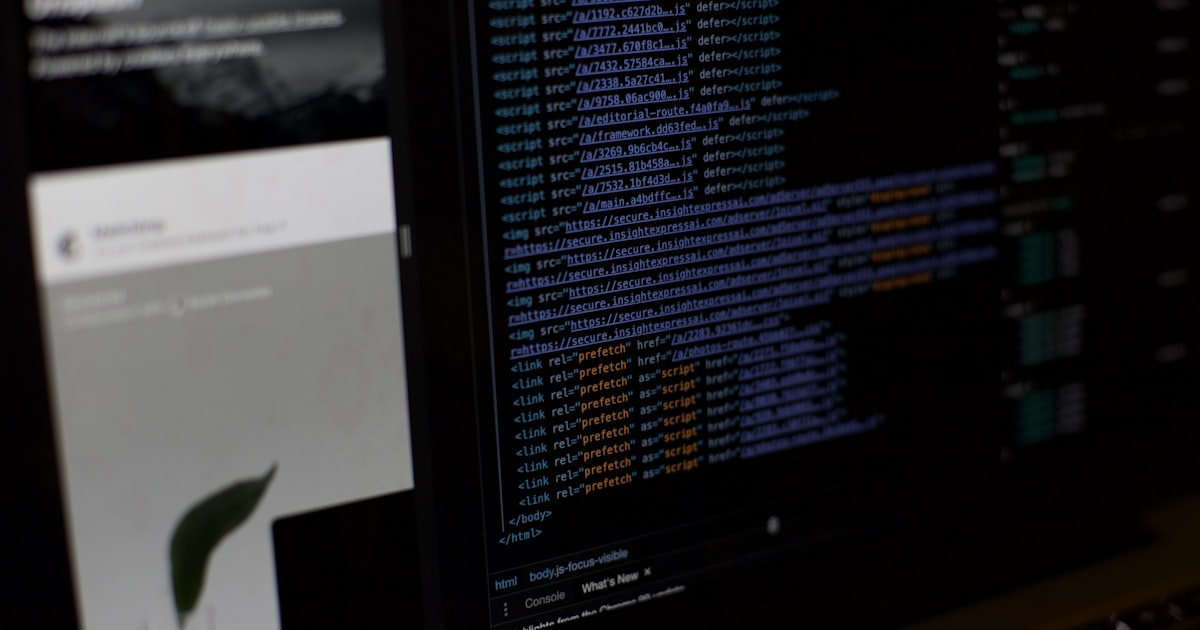 a computer monitor sitting next to a keyboard