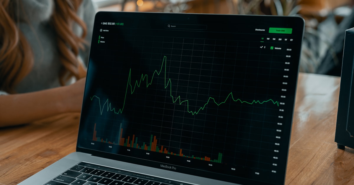 laptop showing stock chart on desk