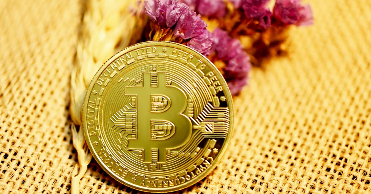 gold round coin on white textile