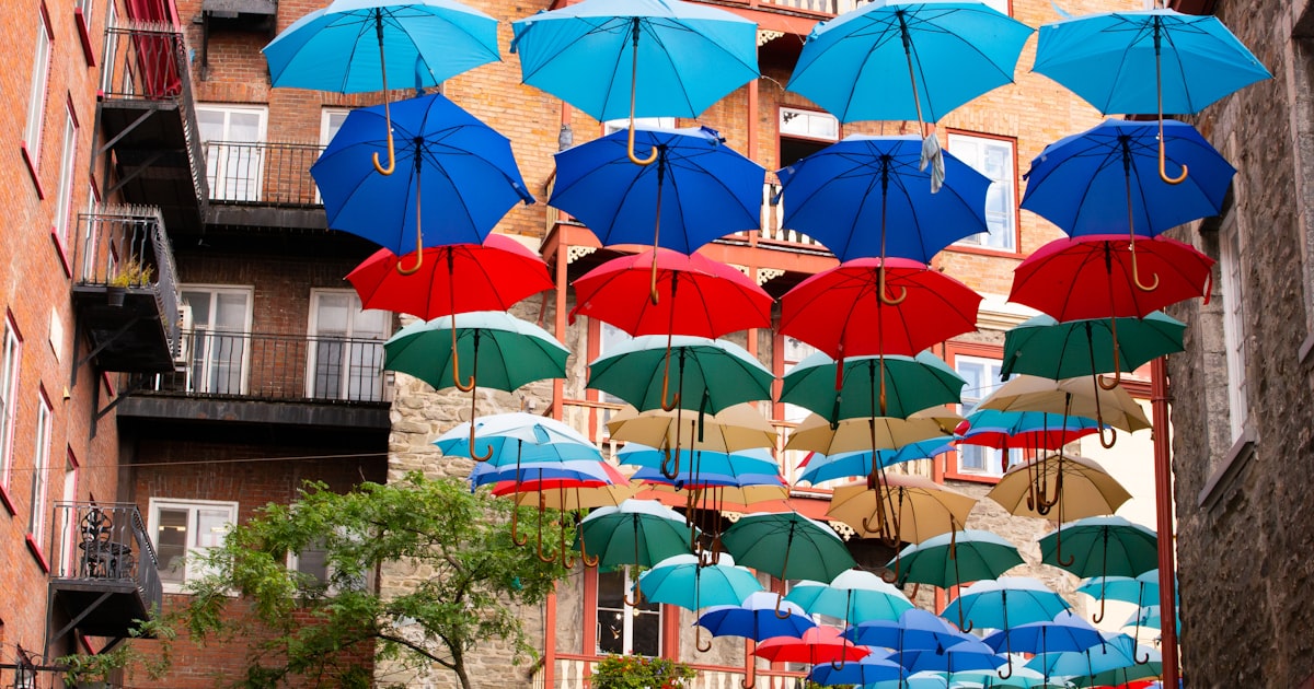Colorful umbrellas suspended above a narrow street.