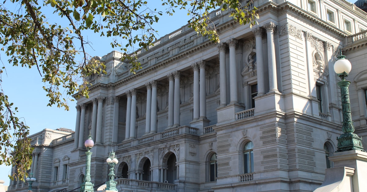 A large white building with a clock on the top of it