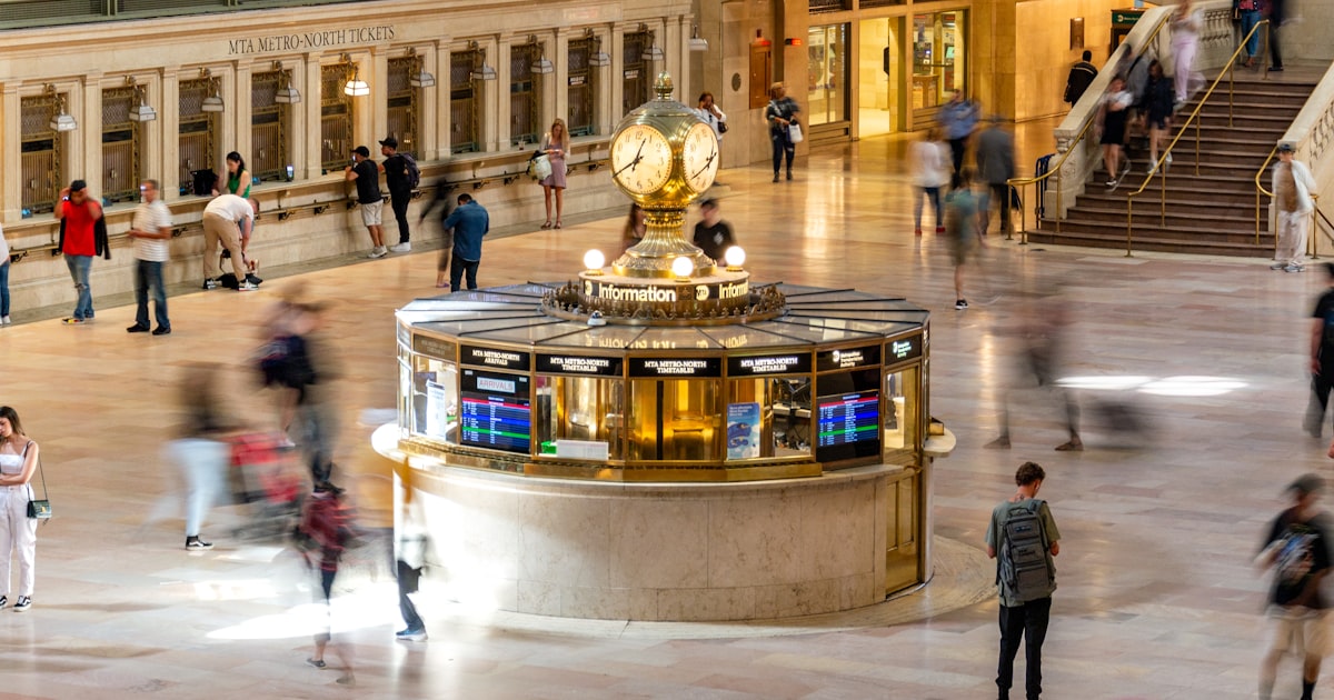 Busy grand central terminal with people rushing around.