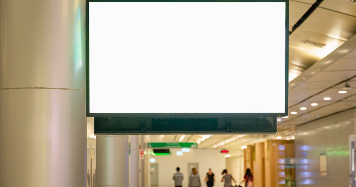 a large white sign hanging from the side of a building