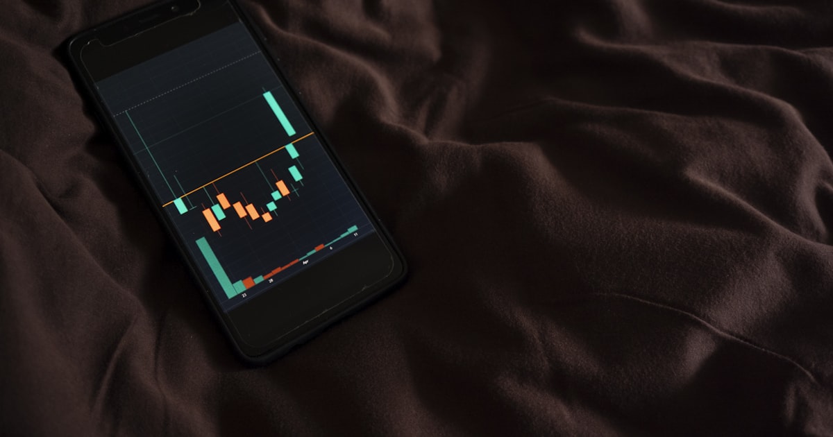 a cell phone sitting on top of a bed
