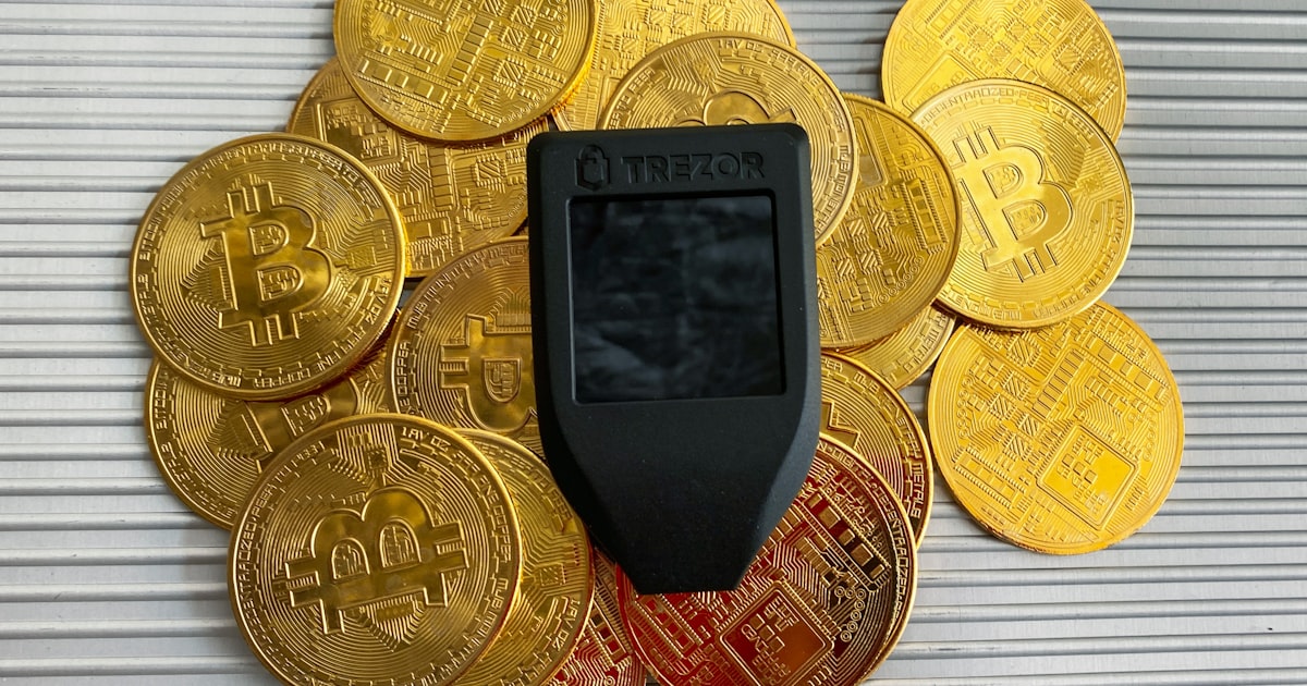 a cell phone sitting on top of a pile of gold coins