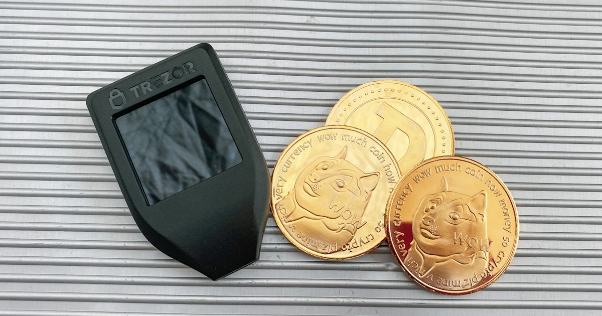 a digital camera next to a pile of gold coins