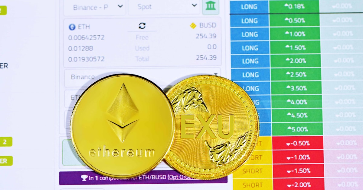 gold round coin on white paper