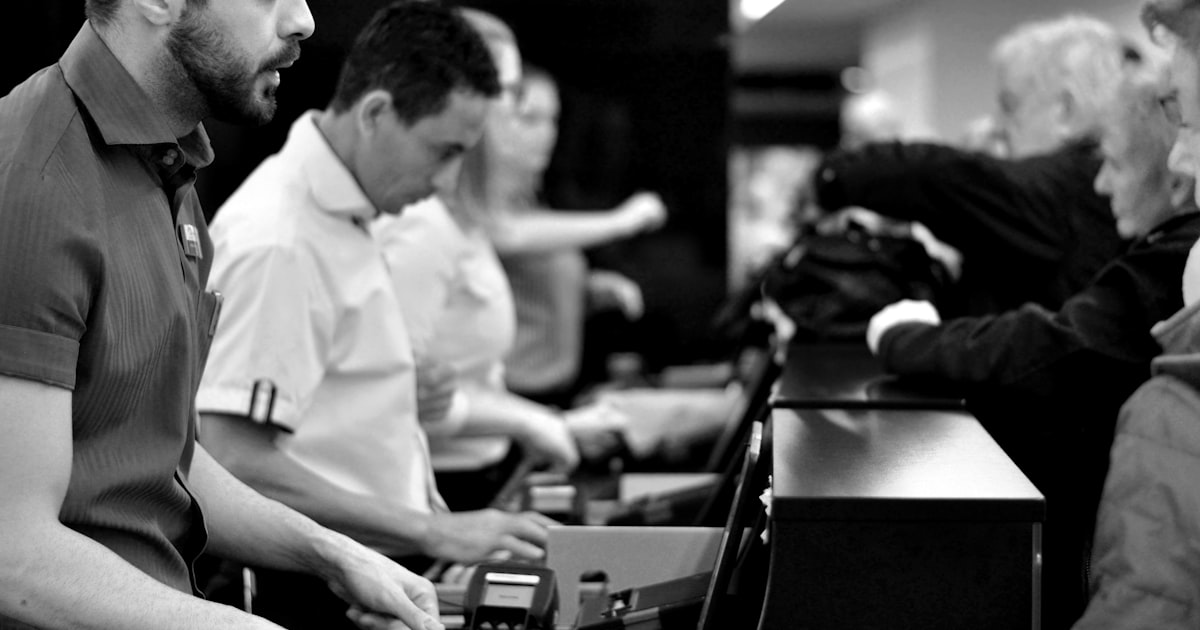 A group of people standing around a counter