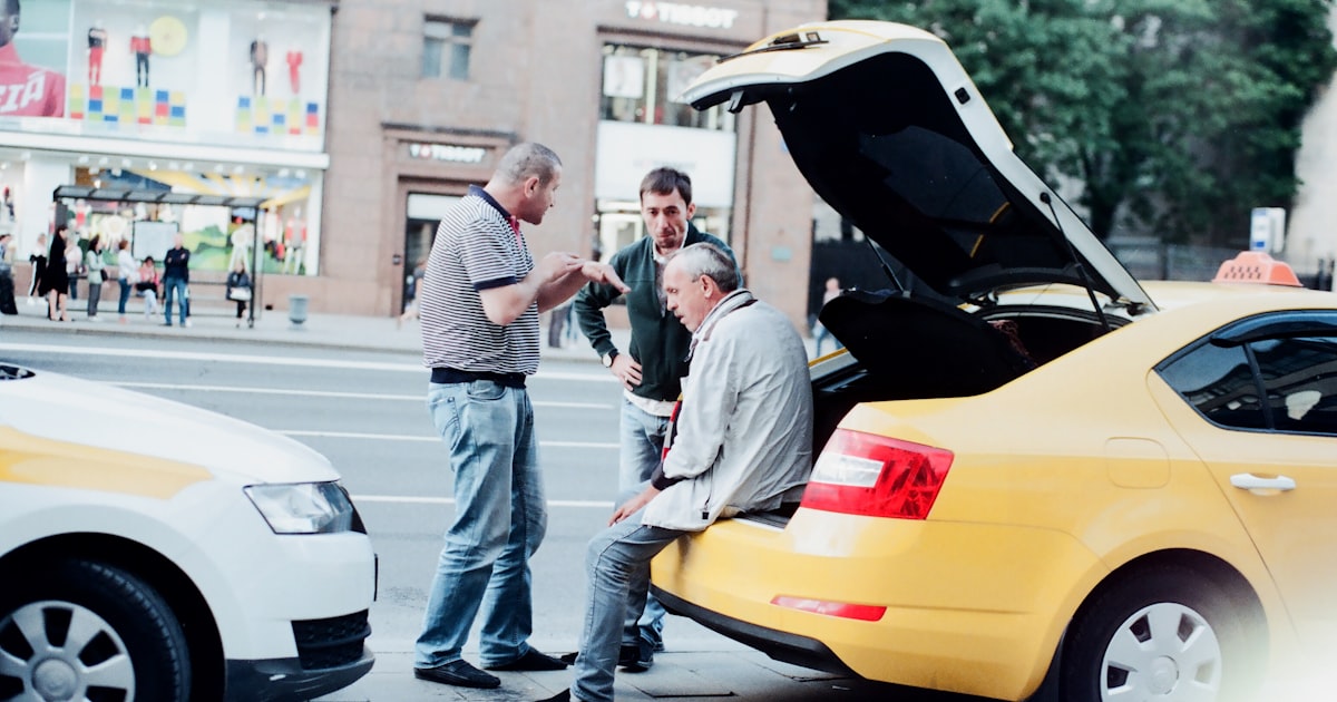 man in gray dress shirt and gray pants holding woman in gray long sleeve shirt