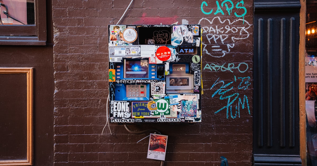 A wall-mounted electrical box covered in stickers.