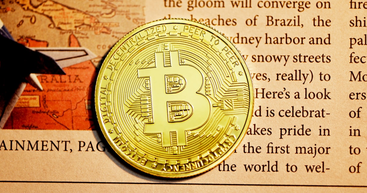 gold round coin on brown paper