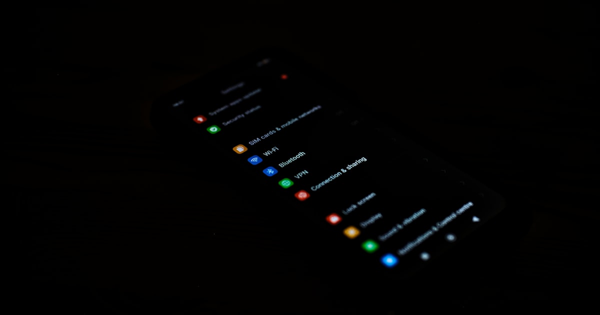 A smartphone screen displaying app icons in darkness