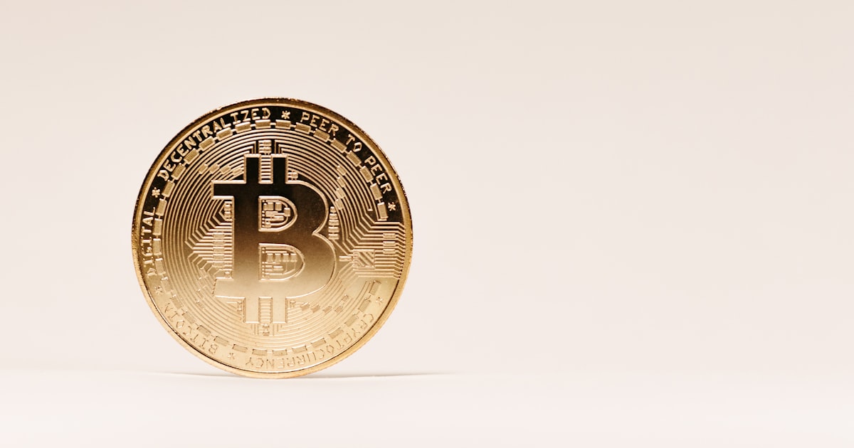a gold bit coin sitting on top of a table