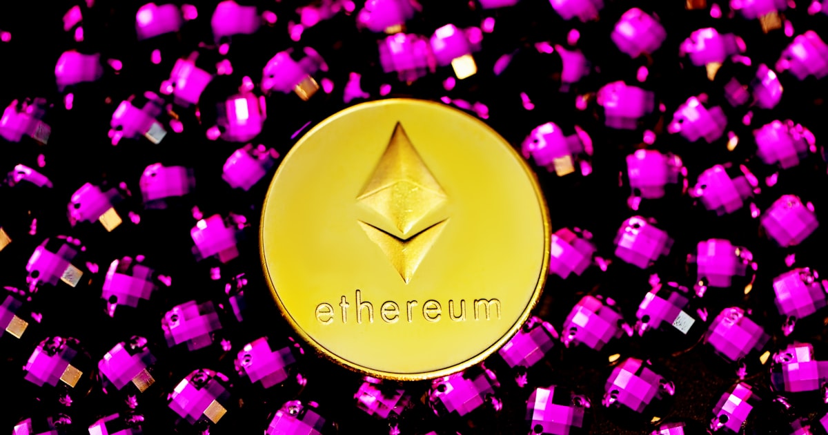 gold heart shaped ornament on pink and purple textile