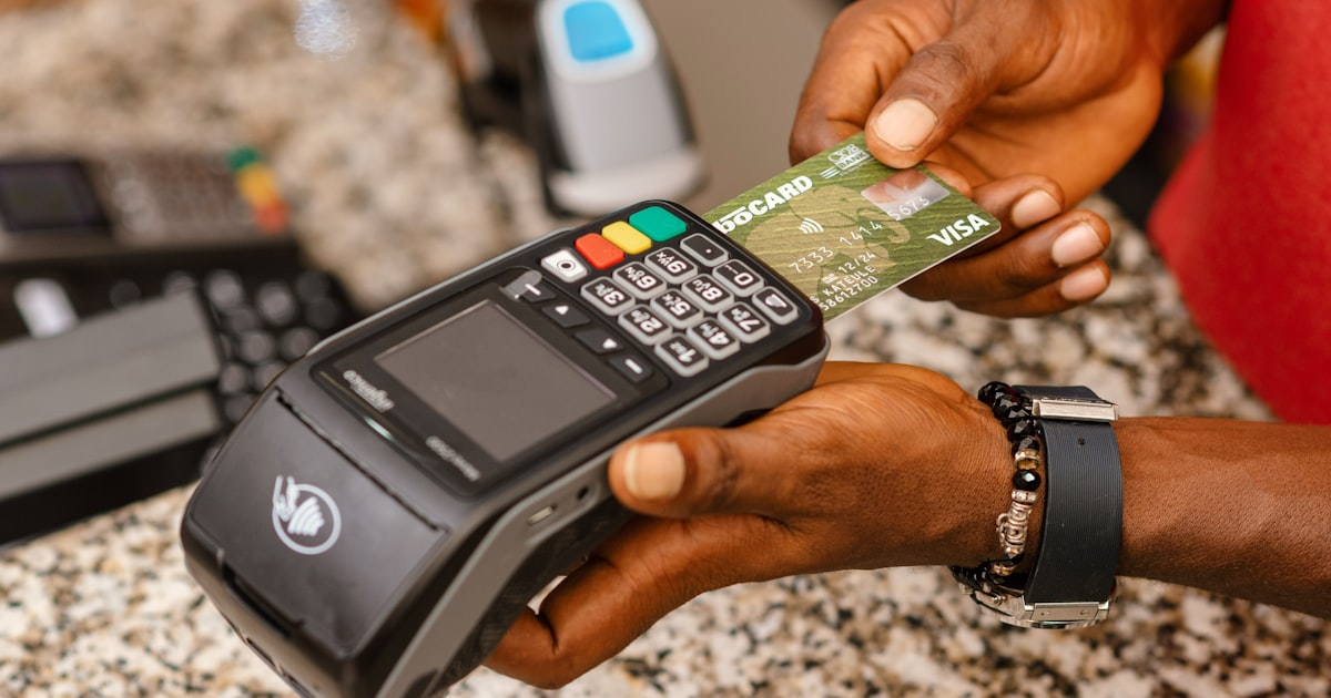 a person holding a credit card in their hand