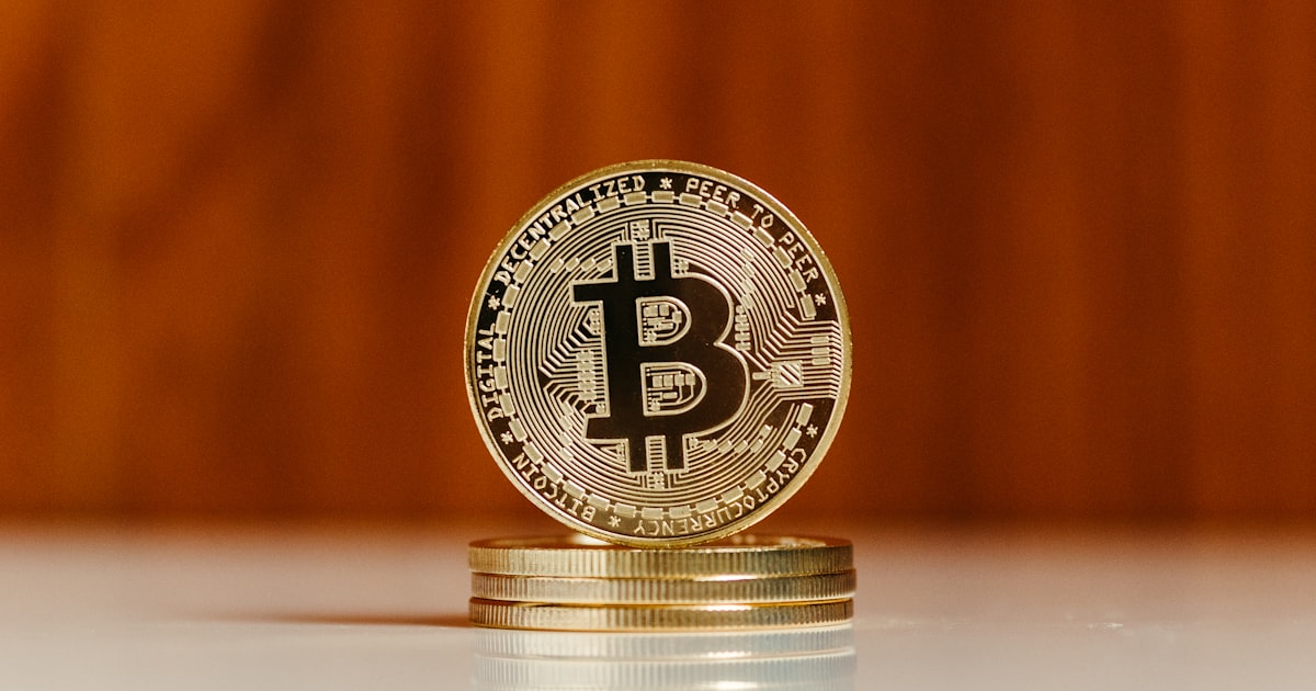 a bit coin sitting on top of a stack of coins
