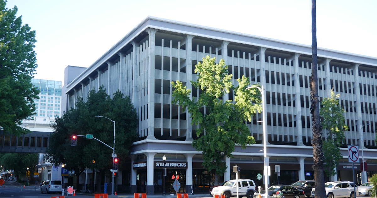 a large white building sitting on the side of a road