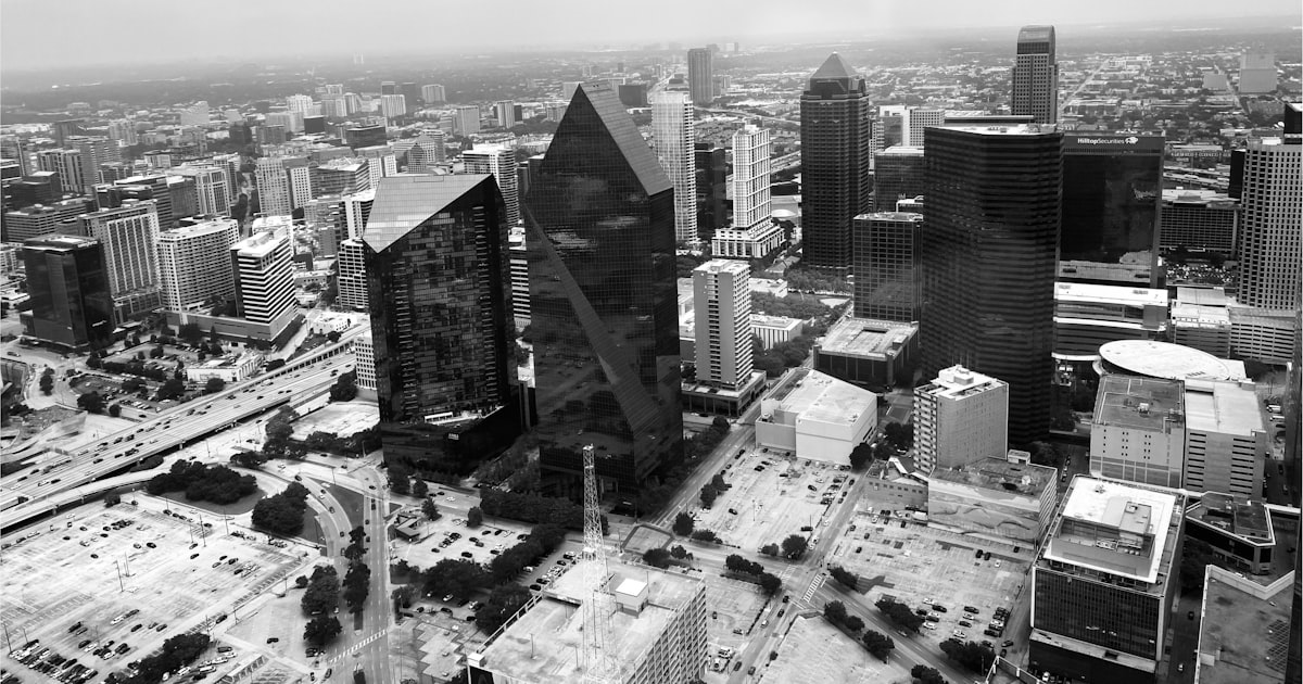Aerial view of a modern cityscape with tall buildings.