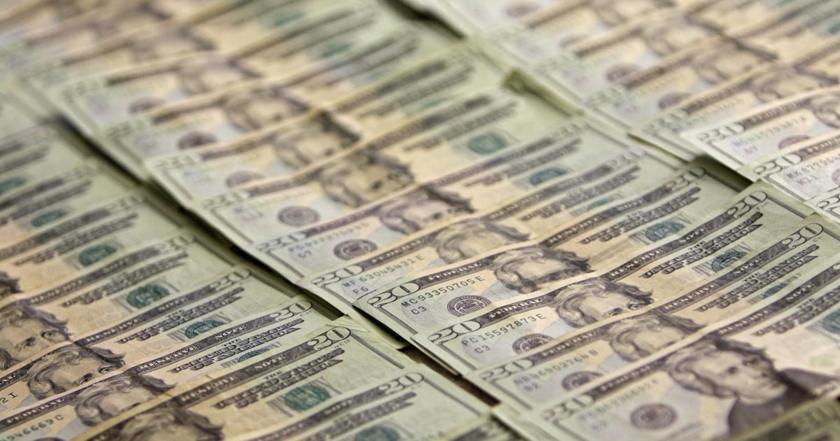 A pile of money sitting on top of a table