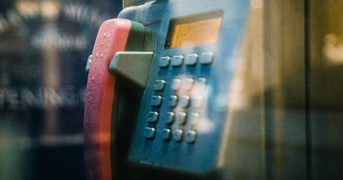 blue and red digital corded phone