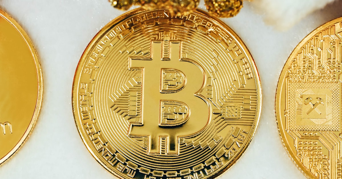 three gold bitcoins sitting next to each other