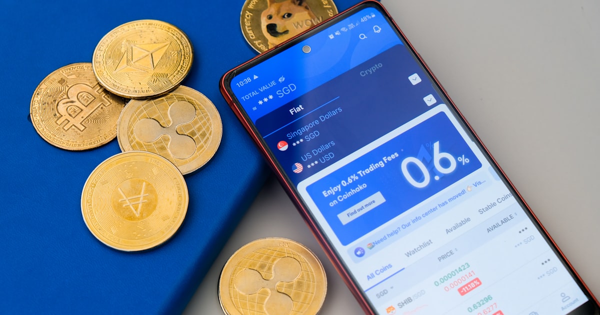a cell phone sitting next to a pile of coins