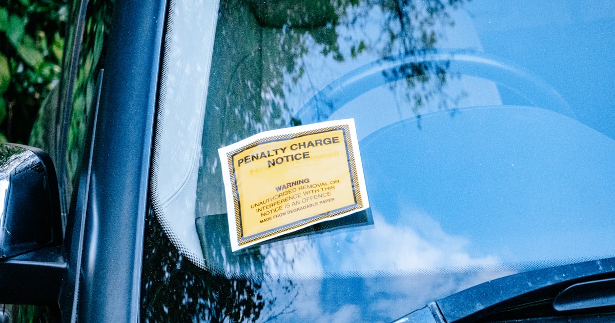 a car with a yellow sign attached to it's side window
