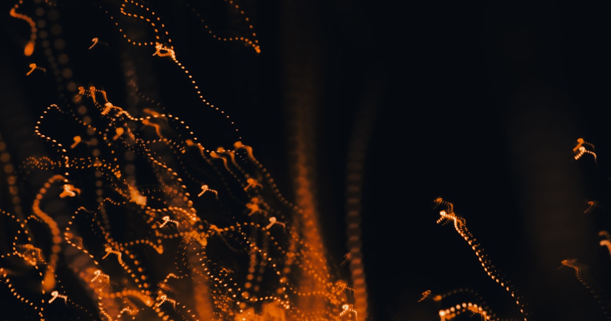 Abstract glowing orange trails against dark background