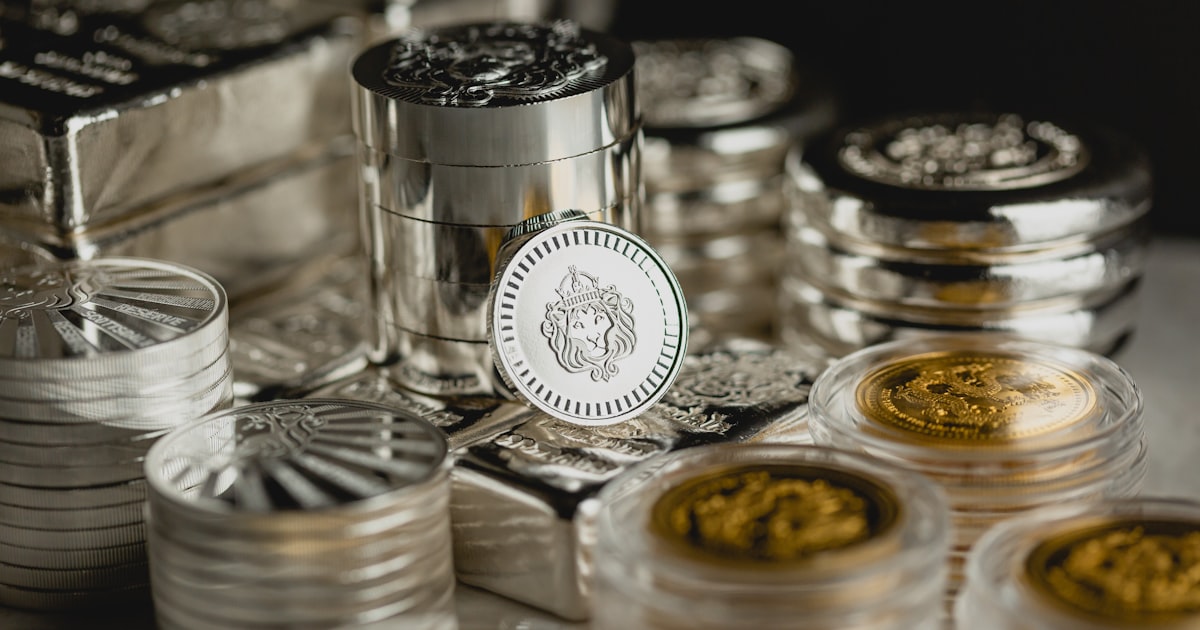 a table topped with lots of silver and gold coins