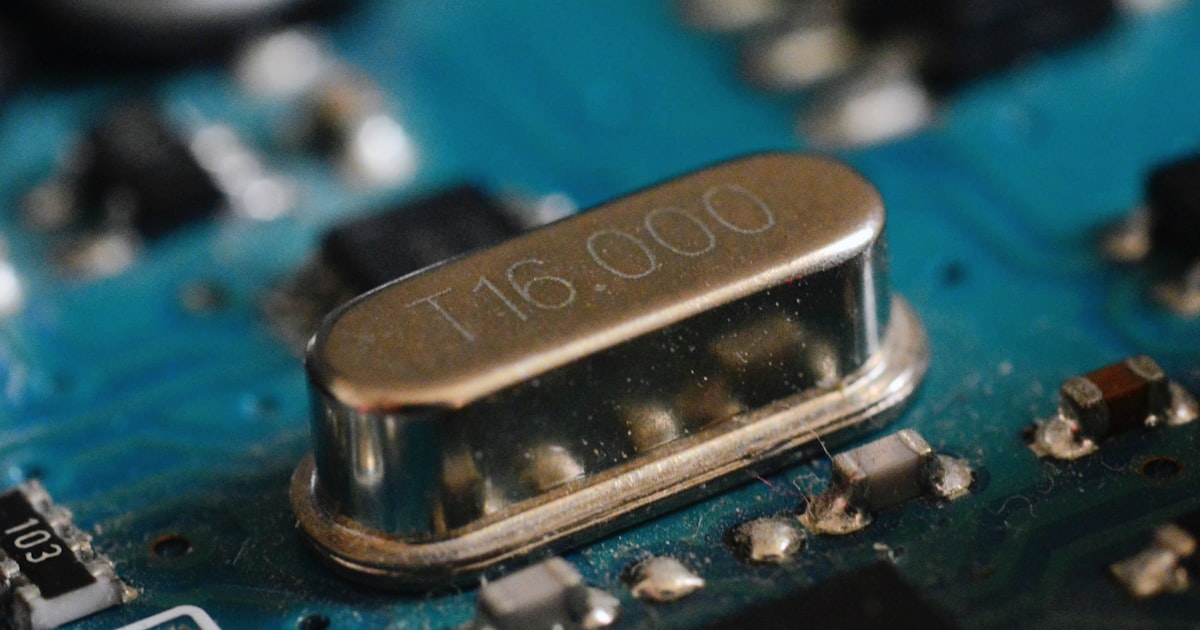 Close-up of a crystal oscillator on a circuit board.