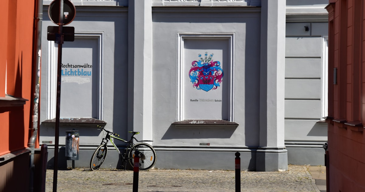 gray bicycle parks beside building
