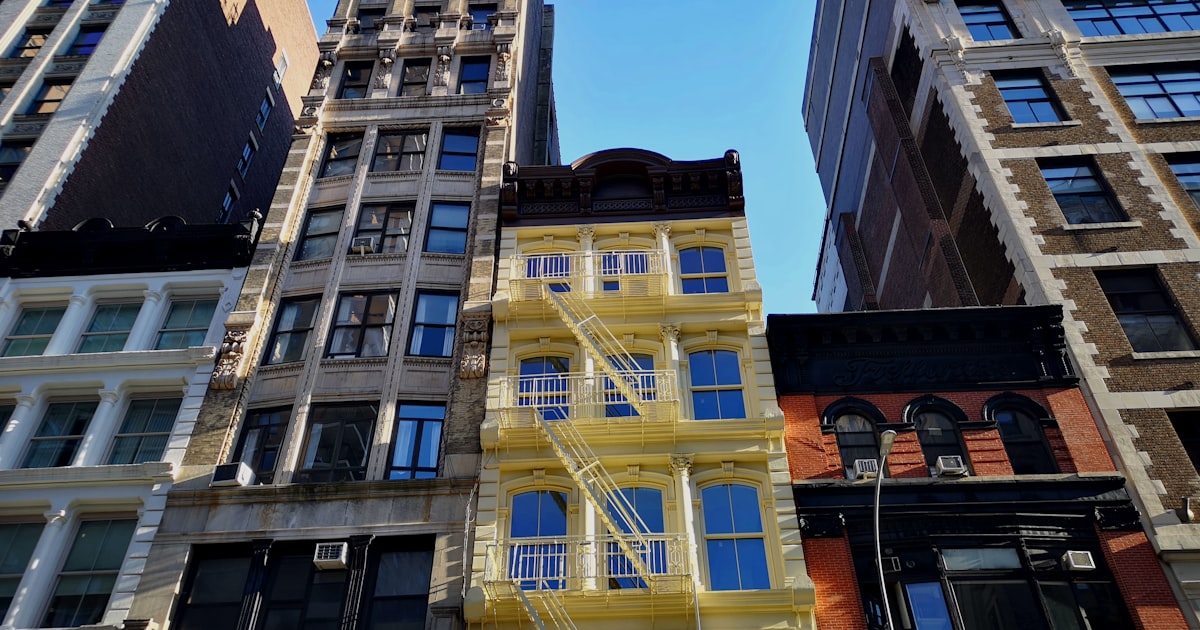 a group of tall buildings with windows and balconies